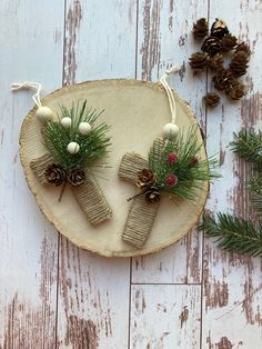 pine cones and twine wrapped in burlocks are displayed on a piece of wood