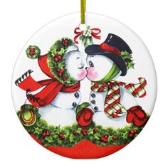 a christmas ornament with two snowmen kissing