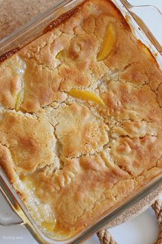 a casserole dish with peaches in it sitting on a plate next to a rope