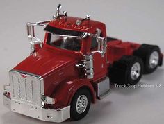 a red toy truck on a white surface