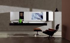 a chair and ottoman in front of a book shelf