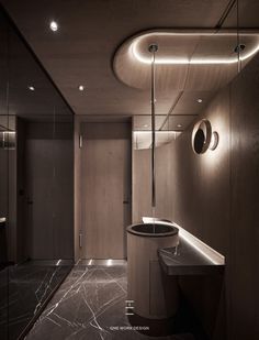 an elegant bathroom with marble counter tops and round lights on the ceiling, along with dark wood paneling