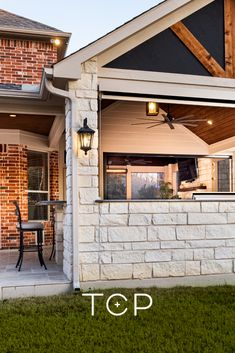 a brick house with an attached porch and patio