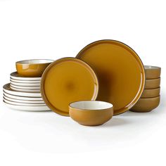 a stack of yellow and white dishes on top of each other