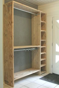 an empty closet is shown with shelves and shelving unit in the middle of it