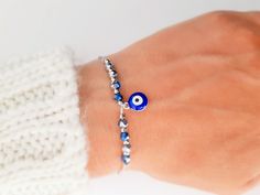 "Unique and elegant bracelet made just for you. Beautiful bracelet, in the color of your choice, with blue evil eye charm in silver or gold details, depinding on your choice . A very cute beaded everyday bracelet, fit on all wrists. Made from color string, with blue evil eye charm surrounded by crystal beads in icy blue color. , macrame slide lock closure. When a person wears an evil eye with them, it guards against misfortune and from bad things happening. Protective Evil eye Talismans like thi Blue Evil Eye Charm Bracelet As Gift, Blue Nickel-free Crystal Bracelet Gift, Blue Nickel-free Crystal Bracelet For Gift, Adjustable Blue Symbolic Bracelet, Symbolic Blue Bracelet Jewelry, Silver Hand-strung Friendship Bracelet As Gift, Hand-strung Silver Friendship Bracelets As Gift, Blue Hypoallergenic Charm Bracelet For Gift, Blue Hypoallergenic Crystal Bracelet As Gift