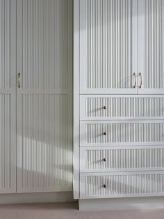 a white closet with two doors and drawers