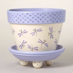 two blue and white bowls with dragonflies painted on the sides, one is holding three eggs