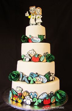 a three tiered wedding cake with cartoon characters on the top and bottom layer, decorated in white frosting