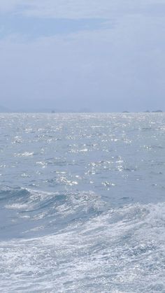 a man riding a surfboard on top of a wave in the ocean