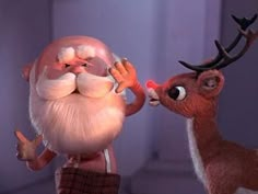 an animated santa clause is kissing a reindeer's nose in the film rudolph and mrs claus