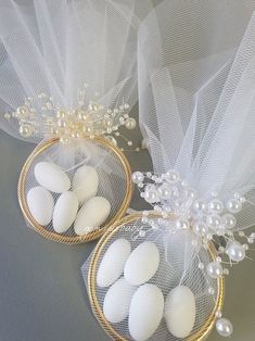 two baskets filled with white eggs on top of a table