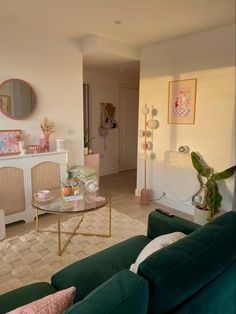 a living room filled with furniture and a mirror on the wall next to a coffee table