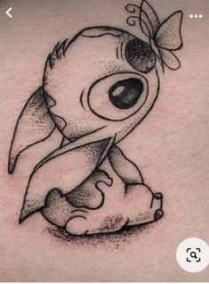 a cartoon character tattoo on the back of a woman's stomach, which has been drawn