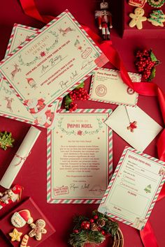 the wedding stationery is laid out on red paper