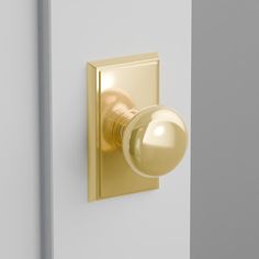 the door knob is shiny gold and has a glass ball on it's side