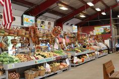 an outdoor market with many fruits and vegetables