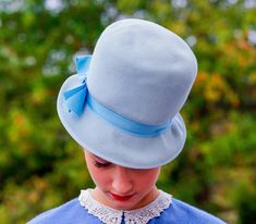 "DESCRIPTION * Vintage mod hat from 1950s-1960s * cloche style: close-fitting high flat crown, short straight brim, designed to be worn low on the forehead * made with wool felt material in baby blue color * the photos with the model illustrate a closer color of the hat * hatband is wrapped with a grosgrain ribbon embellished with a bow on the side * label reads \"Zephyr Felt, 100% Wool, Henry Pollak, Inc, New York/ Union Made, EZ 797922, Made in USA\" CONDITION * there are a few stains on the h Retro Cloche Hat For Kentucky Derby, Vintage Cloche Hat, Retro Cloche Church Hats, Retro Brimmed Cloche Hat For Vintage Events, Retro Cloche Mini Hat For Church, Retro Cloche Hat With Curved Brim For Church, Retro Fitted Cloche Hat, Retro Cloche Hat For Vintage Events, Retro Cloche Hat For Vintage Fashion