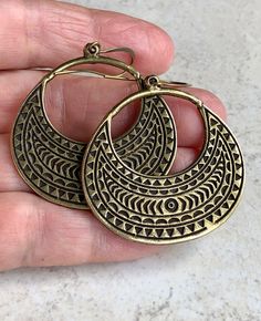 "boho earrings dangle brass open hoop earrings tribal earrings These large, oval hoops are antiqued brass with a recessed, tribal-like pattern, which is on both sides. Hook ear wires are antiqued brass. Length of earrings from top of ear wires is 2 1/4\". Hoops measure 1 1/2\" x 1 5/8\". You can enter my shop here: gypsydangles.etsy.com" Bohemian Bronze Hoop Earrings In Brass, Bohemian Bronze Brass Hoop Earrings, Bohemian Copper Hoop Earrings, Bohemian Bronze Hoop Earrings, Bohemian Gold Copper Hoop Earrings, Bohemian Antique Gold Brass Earrings, Bohemian Antique Gold Copper Earrings, Bohemian Brass Hoop Earrings, Bronze Metal Hoop Earrings For Pierced Ears