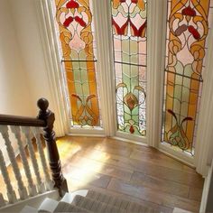 the stairs lead up to three stained glass windows