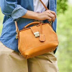 *DOCTOR BAG'S HANDMADE VIDEO*https://youtu.be/QpdhSCjh2BMProduct Description• Material: vegetable tanned leather• Color: yellow• Brass tuck lock to close• 0.75" wide leather shoulder strap adjust from 36.61" to 44.88"• One back slide pocket• Underneath the foot nail• Sewn by hand;• It comes with hanging covered key• Size: 190mm (H) x 260mm (W) x 150mm (D)/ 7.4" x 10.2" x 5.9"• • • • • • • • • • • • • • • • • • • • • • • • • • • • • • • • • • • • • • • • • • • • • • • • • • • • • • • • • About th Foot Nail, Leather Handbags Handmade, Vegetable Leather, Italian Bags, Doctor Bag, Gold Bag, Marken Logo, Best Wallet, Women Handbag