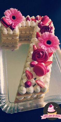 a cake shaped like the letter n with flowers on it