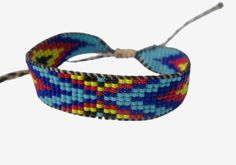 This beaded friendship bracelet is my original design, inspired from the styles and colors of Native American and Huichol Indians of Mexico bead work. It's 9 lines wide, made with size 15 seed beads, smaller than the  traditionally used size11 seed beads. I made it on a loom.   Measurements: just under 1/2" wide and closes at 6", but is expandable to fit larger wrist sizes. You can also contact me with your exact wrist size for a custom fit.    You may also be interested in these similar designs Friendship Bracelets With Beads, I Made It, Braided Bracelets, Friendship Bracelet, Custom Fit, Original Design, Friendship Bracelets, Bead Work, Loom