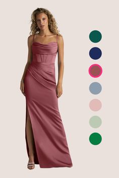 a woman in a long pink dress standing next to color swatches on the wall