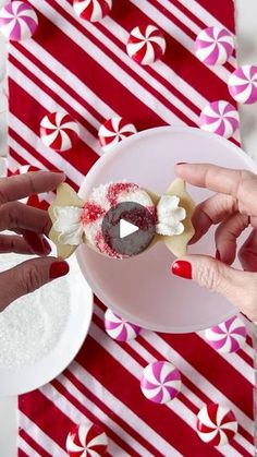 two hands reaching for a piece of food on a plate with candy canes in the background