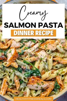 creamy salmon pasta with spinach and pesto in a skillet