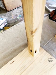 a person working on a piece of wood that is being made into a chair leg