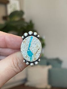 "How beautiful is this stone She has a perfect river of blue running through her making me fell the nature vibes.  I gave her some rustic sterling silver ball as accents and she sits on a floral band in keeping with the nature theme. Measurements:  1.4\" x .8\" Ring Size:  8.5 The color difference in the pics is sun vs shade...no touch ups or filters were added. Turquoise's properties are water-like and can instill a sense of calm within you. It has been celebrated over time as a stone of protection and tranquility.  One of the turquoise's meanings is that of new beginnings and restoring your well-being. When you purchase from Crimson Buffalo you are getting a one-of-a-kind hand- crafted piece of jewelry.  We do not use molds so no two pieces will ever be identical; each will have its own Bohemian Untreated Blue Turquoise Ring, Bohemian Blue Turquoise Ring With Natural Stones, Bohemian Blue Turquoise Ring With Stones, Rustic Blue Jewelry With Natural Stones, Bohemian Turquoise Chrysocolla Ring With Natural Stones, Bohemian Turquoise Ring With Natural Chrysocolla, Bohemian Turquoise Ring With Chrysocolla, Nature-inspired Turquoise Jewelry With Large Stone, Unique Blue Turquoise Ring