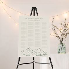 a table plan on a easel with lights in the background