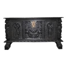 an ornate black cabinet with carvings on it