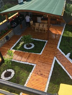 a wooden deck surrounded by grass and rocks