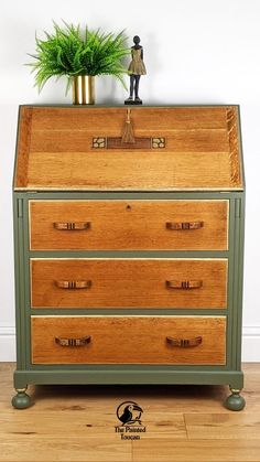 an old dresser with the words vintage bureauau on it and a small potted plant