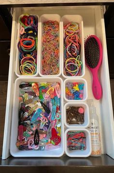 an organized drawer with lots of crafting supplies and toothbrushes in it's trays