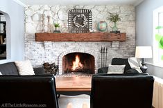 a living room with two chairs and a fire place in the center, along with a fireplace