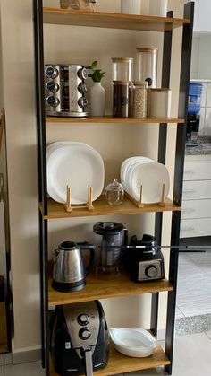 the shelves are filled with dishes and appliances