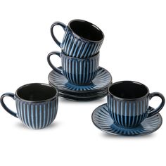 three blue cups and saucers sitting on top of each other with black rims