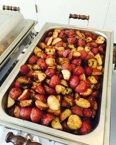 a pan filled with potatoes sitting on top of a stove