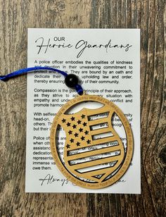 an american flag ornament hanging on a book page with a blue ribbon and the words, our home gardens