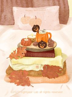 a pile of books sitting on top of a bed covered in fall leaves and pumpkins