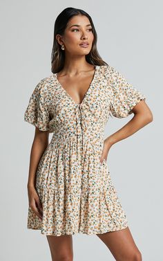 Make a stylish statement in the Chetana Mini Dress. This stunning white and yellow floral dress is perfect for those casual summer days, with its comfortable smock style and short sleeves. The v-neck adds a touch of femininity, while the tiered design creates a flattering silhouette. Made from soft and breathable viscose fabric, this mini dress is not only fashionable but also comfortable to wear all day long. Whether you're heading to brunch or exploring a new city, the Chetana Mini Dress will Basic Black Dress, Neon Outfits, Spring Maxi Dress, Bachelorette Dress, Virtual Wardrobe, Short Sleeve Summer Dresses, Nashville Outfits, Navy Bridesmaid Dresses, Yellow Floral Dress