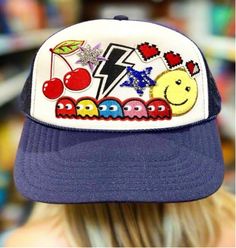 Pac-Man and Ghosts are Ready2Go on their next adventure! This fun iconic pop culture gaming hat will be a fun conversation starter! The blue and white color scheme, featuring Pac-Man and Ghosts, adds a fun touch to any outfit. Made from breathable polyester material, this hat is perfect for travel and casual occasions. The adjustable mesh back and one-size-fits-all design ensure a comfortable fit for all adults. Whether you're a fan of Pac-Man or just looking for a stylish accessory, this trucker hat is the perfect addition to your wardrobe. Playful Blue Trucker Hat For Summer, Playful Blue Summer Trucker Hat, Playful Blue Snapback Trucker Hat, Fun Blue Trucker Hat, Playful Blue Trucker Hat With Curved Brim, Fun Blue Hat With Curved Brim, Blue Curved Brim Playful Hat, Playful Blue Trucker Hat, One Size Fits Most, Blue Adjustable Themed Hat