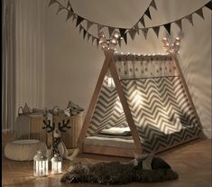 a bedroom with a teepee bed and pillows on the floor