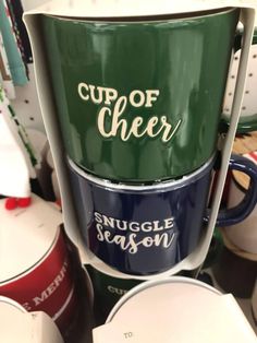 several cups stacked on top of each other with the words cup of cheer written on them