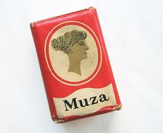 an old match box with a woman's head on the front and word muza