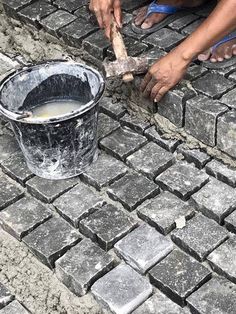 a man is pouring cement into a bucket