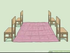 a bed with two chairs and a pink blanket